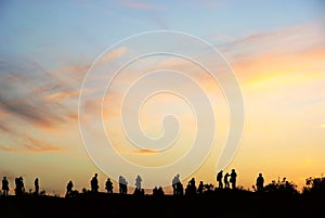 People and sunset clouds