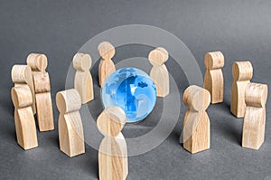People surrounded a Globe world planet earth. Cooperation and collaboration of people around the world. Outsourcing and joint work