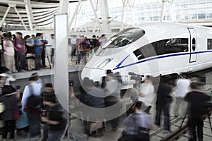 People surrounding and filming the high speed railway train