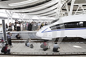 People surrounding and filming the high speed railway train