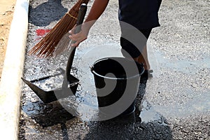 People are sweeping dirty water at ground streets, cleaner floor, housemaid, housekeeper, homemaker, maidservant, maid photo