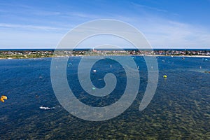 People swim in the sea on a kiteboard or kitesurfing. Summer sport learning how to kitesurf. Kite surfing on Puck bay in Jastarnia