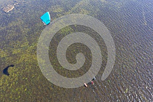 People swim in the sea on a kiteboard or kitesurfing. Summer sport learning how to kitesurf. Kite surfing on Puck bay in Jastarnia