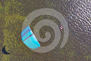 People swim in the sea on a kiteboard or kitesurfing. Summer sport learning how to kitesurf. Kite surfing on Puck bay in Jastarnia