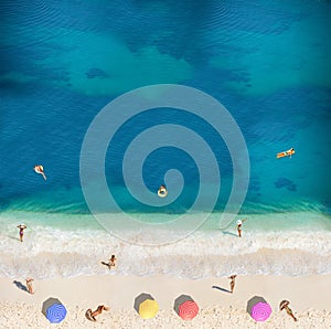 People swim, sunbath on the beach view from above