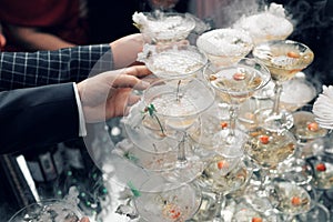 People take the glasses of champagne pyramid. close-up