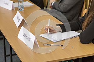 People taking notes on a notebook at a conference 