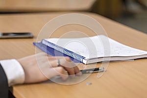 People taking notes on a notebook at a conference 