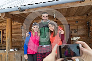 People Taking Photo On Smart Phone Group Wooden Country Mountain House Winter Snow Resort