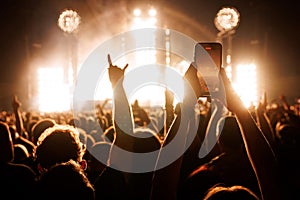 People Taking Photos At A Music Concert With Smartphones