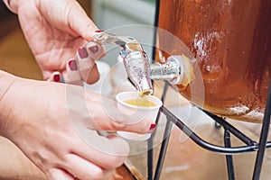 People taking sweet fruit juice from dispenser in morning breakfast time