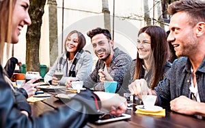 People tasting hot drinks at coffee restaurant dehor - Milenial friends talking and having fun together at sidewalk cafe