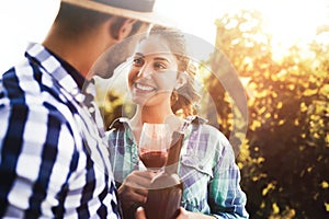 People tasting wine in vineyard