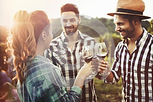 People tasting wine in vineyard