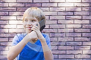 People, technology and communication concept. Child talking on cell phone