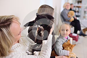 People with their pets are waiting for a medical examination at the veterinary clinic. Animal Health