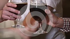 People, toast, leisure, friendship and celebration concept - happy male friends drinking beer and clinking glasses at