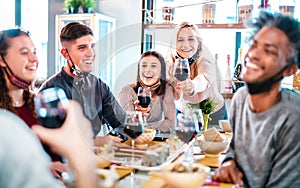 People toasting red wine at fashion restaurant bar with open face mask - New normal lifestyle concept with happy friends