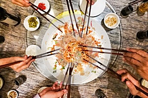 People tossing yee sang or yusheng during Chinese New Year