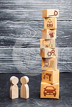 People and a tower of cardboard boxes with goods. Buying and selling goods services. Trade relations. The economic crisis and new