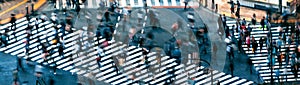 People and traffic cross the famous scramble intersection in Shibuya, Tokyo, Japan