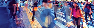 People and traffic cross the famous scramble intersection in Shibuya, Tokyo, Japan