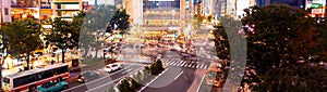 People and traffic cross the famous scramble intersection in Shibuya, Tokyo, Japan