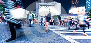 People and traffic cross the famous scramble intersection in Shibuya, Tokyo, Japan