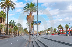 People & traffic, late afternoon in seaside Barcelona, Spain.