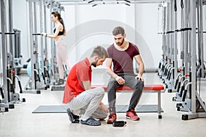 People with trainer at the rehabilitation gyum