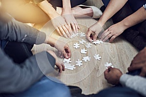 People, training and hands with puzzle on table for problem solving, learning and integration of strategy. Diversity