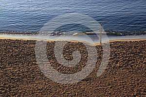 People trampled sand on the Mediterranean Sea beach