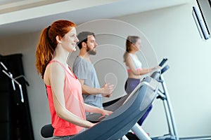 People traning in gym on various machines
