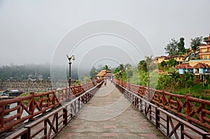 People travel and waiking on Saphan Mon wooden bridge in morning