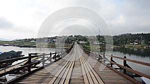 People travel and walk on Saphan Mon wooden bridge at Sangkhlaburi