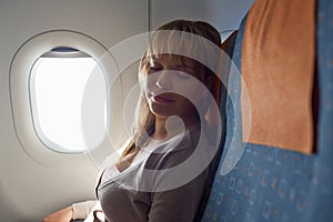 People travelling relaxed woman sleeping on plane