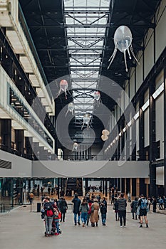 People under aerobes of Anicka Yi`s installation In Love With The World in Turbine Hall of Tate Modern, London, UK