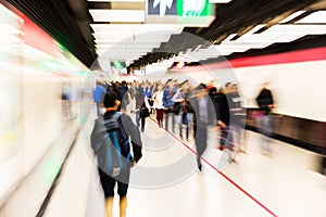People in an underground station with zoom effect