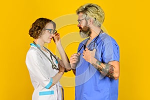 People in uniforms yellow background. Medical staff. trust our professionals. healthcare business. teamwork and people