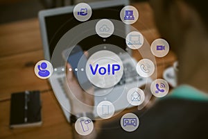 People using IP phone / Smartphone with flying icon of voip services and people connection, Smart VoIP and telecommunication