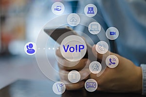 People using IP phone / Smartphone with flying icon of voip services and people connection, Smart VoIP and telecommunication