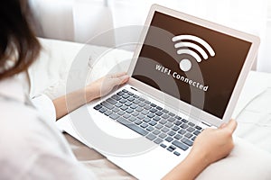 People using laptop connect to Internet using WIFI access point home network system