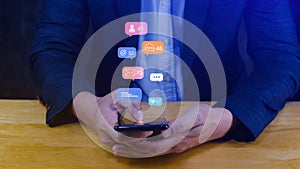 People using social media and digital online marketing concepts on mobile phones with icons such as notifications, messages,