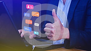 People using touching social media and digital online marketing concepts on laptop with icons such as notifications, messages,