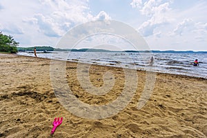 People in various activities on the beach of lake Dwight, Ontario, Canada photo