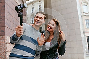 People Video Blogging On Camera On Street. Couple Taking Photos