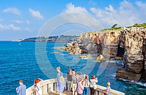 People visit Boca do Inferno, famous attraction in the coast of Cascais, Portugal. Hell`s Mouth is touristic