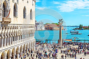 People visit the San Marco embankment in Venice, Italy. Doge`s Palace on left