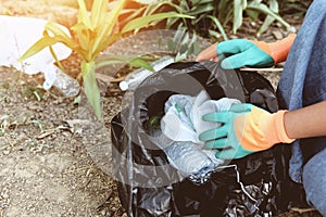 People volunteers helping to keep nature clean and picking up the garbage from park - Recycling and waste reduction techniques