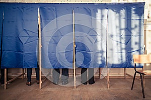 People vote in voting booth